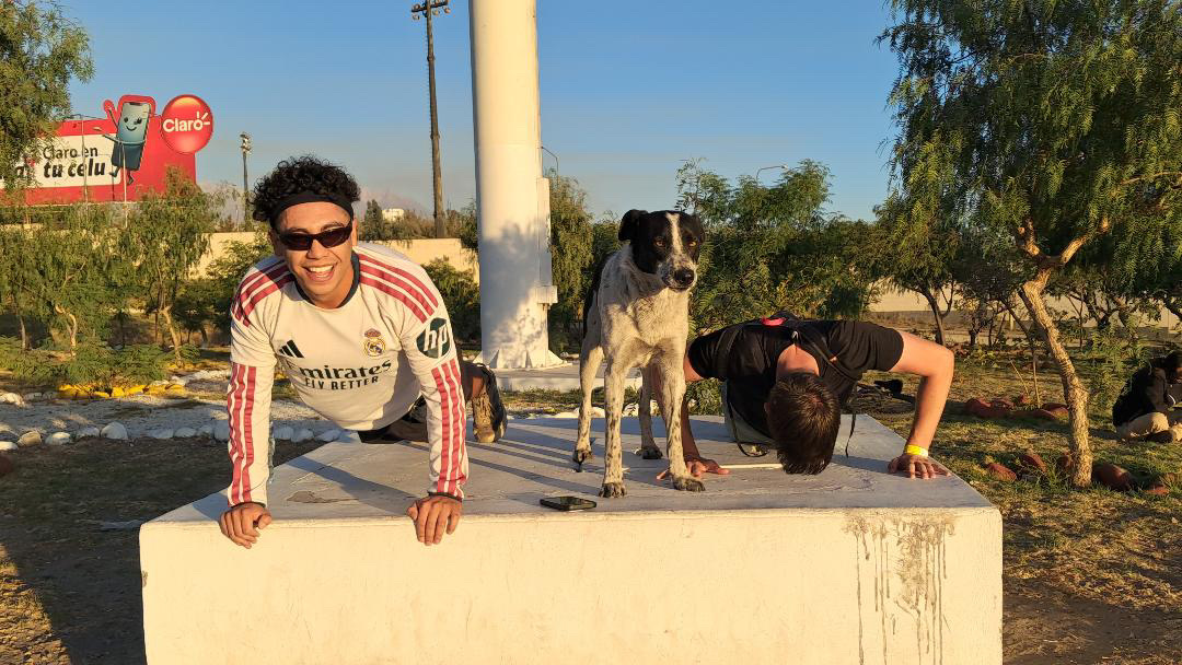 Run Club participants doing push-ups with a dog in Arequipa