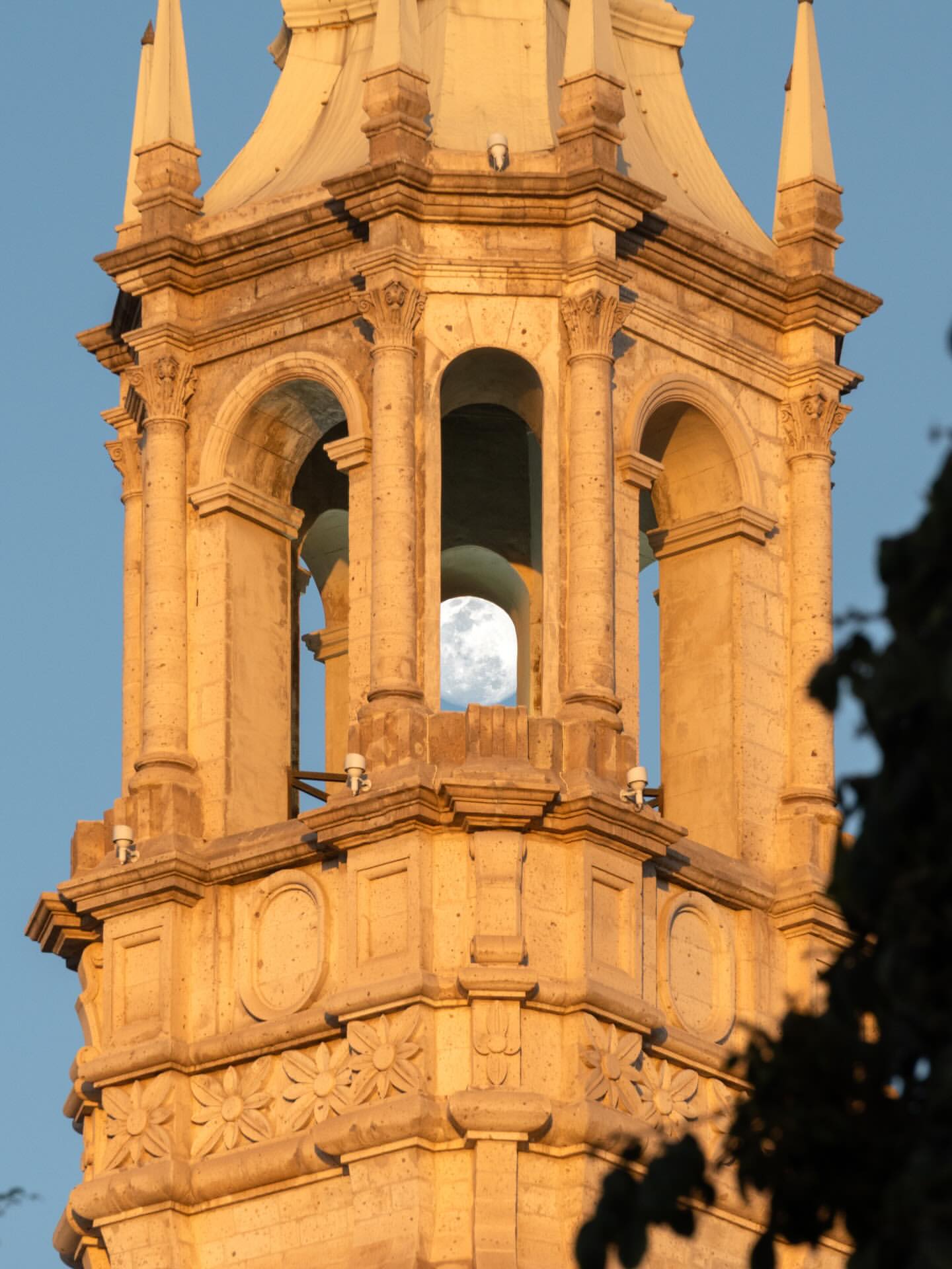 Historic cathedral bell tower glowing in golden light