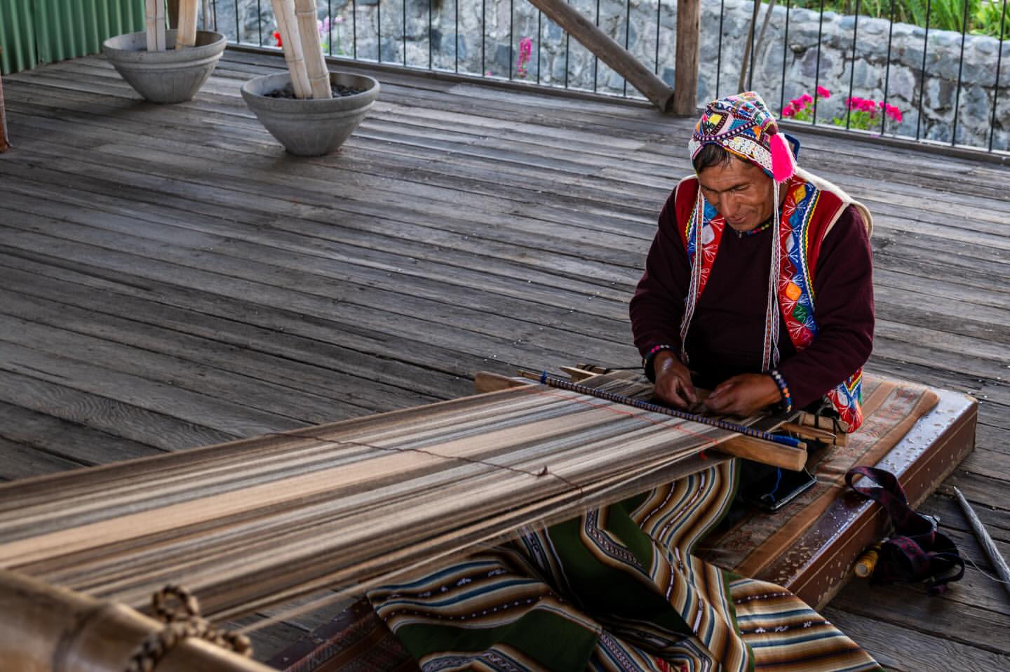 Andean artisan weaving textiles on a traditional loom