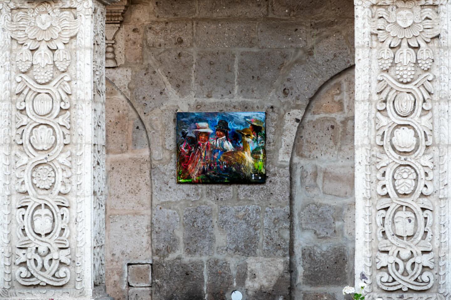 Colorful painting between ornate carved volcanic stone columns