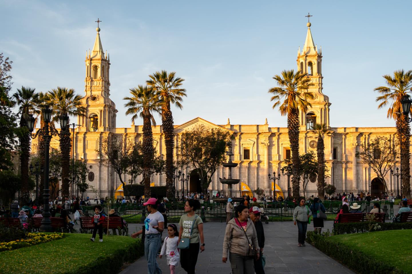 People in Plaza de Armas with Arequipa Cathedral at golden hour